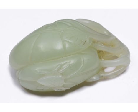 A CHINESE WHITE JADE PEBBLE carved as fruits and foliage on openwork branches, 19th/20th Century, 5.5cm high