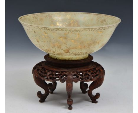A CHINESE JADE AND GILT BOWL in the Mughal style decorated with dragons flying amongst foliage, with four character Qianlong 