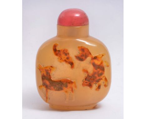 A CHINESE PALE BROWN AGATE OVIFORM SNUFF BOTTLE, the natural light brown inclusions carved in high relief with dog of fo, dee