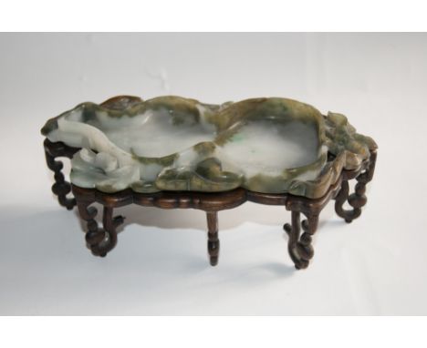 A CHINESE MOTTLED GREEN AND WHITE JADE BRUSH WASHER TRAY in the form of double gourd surrounded by openwork foliage, with har