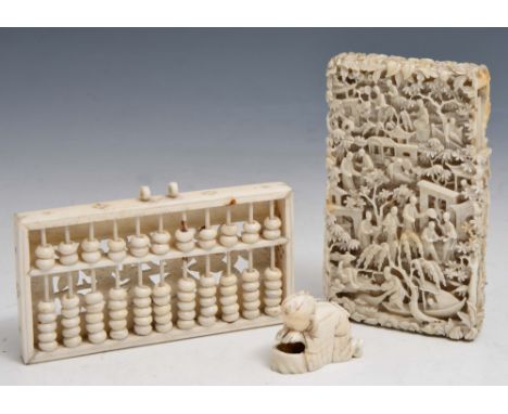 A CHINESE CANTON CARVED IVORY VISITING CARD CASE with temple and figures, a carved Chinese abacus and a Japanese carved netsu