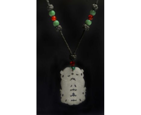 A CHINESE WHITE JADE PENDANT pierced and carved as exotic birds with silk cord mounted with mottled green jade and chalcedony