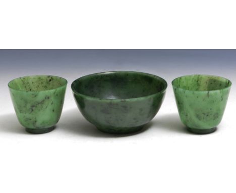 TWO CHINESE JADE SPINACH CUPS, 7.5cm and a Chinese spinach jade bowl, 12cm