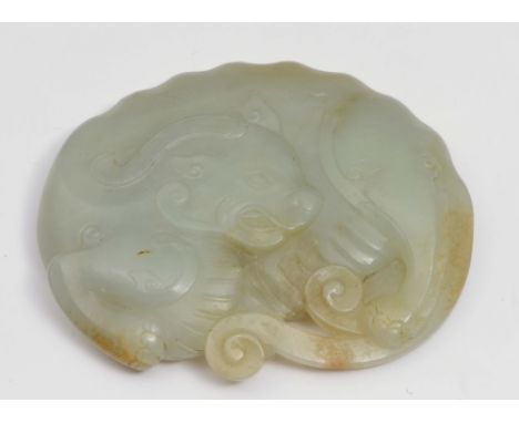 A CHINESE JADE CARVING OF A SINGLE HORNED BUDDHIST LION, the head looking backwards, the backbone with well extenduated nodul