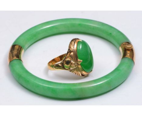A JADE BANGLE and a signet ring, each with 18ct gold mounts, the ring 2cm across, the bangle 7cm across