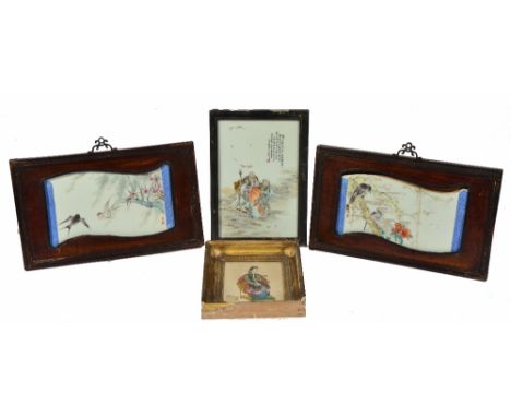 A PAIR OF CHINESE PORCELAIN PANELS with swallows and other birds with flowering blossom in hardwood frames of scroll form, 37