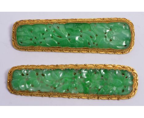 A PAIR OF CHINESE GILT BAR BROOCHES of rectangular form with pierced settings and carved jade settings, 7cm