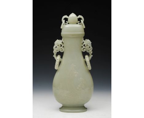 A CHINESE PALE CELADON JADE VASE and cover of flattened baluster form carved in low relief with Guanyin standing upon a flowe