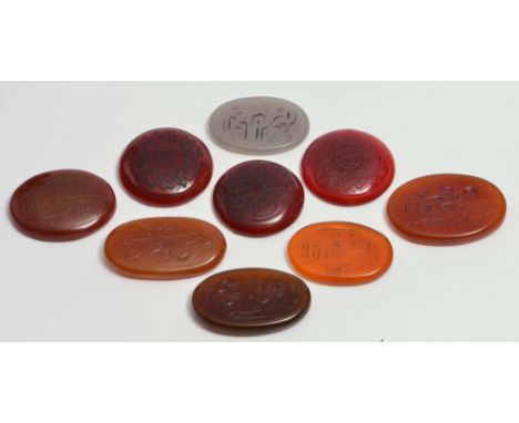 A GROUP OF EIGHT PERSIAN AGATE PLAQUES, and one jade oval plaque, each with intaglio inscriptions in nastaliq, late 18th/earl