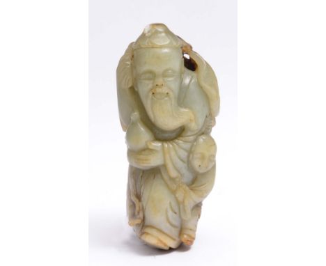 A CHINESE JADE FIGURE OF SHULAO standing holding a gourd, a spray of fungus and accompanied by a child, mid 19th Century, 10c