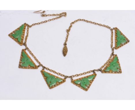 A CHINESE GILT NECKLACE with filigree decoration and carved jade setting, stamped China, silver