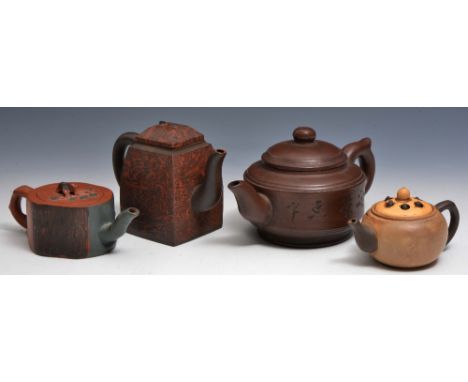 A COLLECTION OF FOUR CHINESE YIXING TEAPOTS, the largest with incised calligraphy