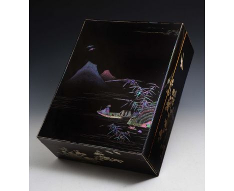 A JAPANESE SOMADO LACQUER KOBAKO decorated in hiramakiye manner with mother of pearl showing a river scene with bamboo and ro