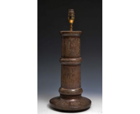 AN EGYPTIAN COPPER LAMP BASE engraved with domestic scenes, early 20th Century, 35cm