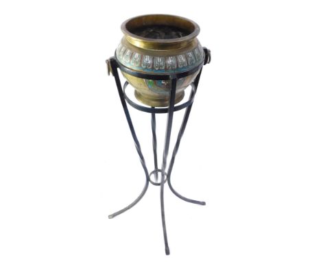 An Eastern champleve enamel and brass jardinere on stand, the pot picked out in green, blue, red and white detail, with two s