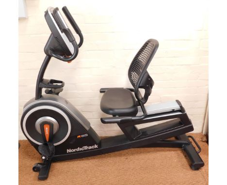 A Nordic Track R65 recumbent exercise bike, with handbook and tools. 
