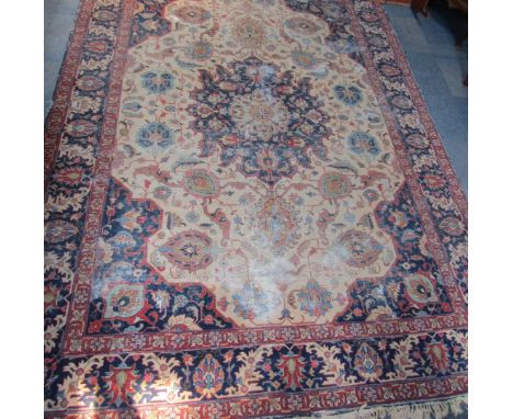 A Persian carpet, on a blue and red ground with central three section medallion, on tassel ends, worn, 350cm x 258cm.