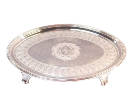 A William IV silver card tray, with fluted outer border and central crest emblem, with wheat sheaf surround, on four claw fee