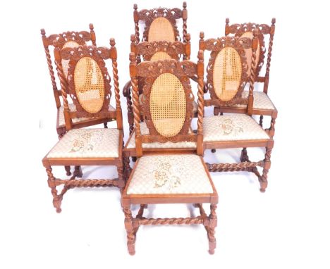 A set of seven oak dining chairs, each with a carved and caned back on bobbin turned supports, including one carver.