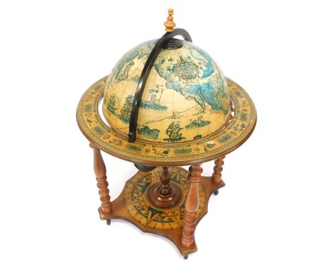 A spinning globe cocktail cabinet, with applied design, zodiac symbols to ring, 103cm high, 66cm diameter. (AF)