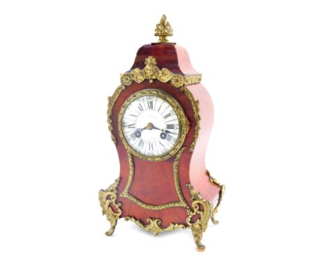 A late 19thC French tortoiseshell mantel clock, with applied brass flower finials, with a white Roman numeric ceramic dial in