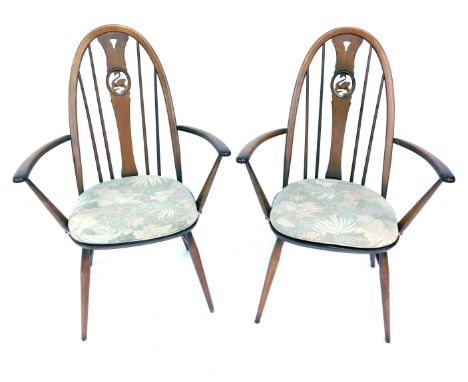 Two Ercol armchairs, each with a carved swan splat, 100cm high.