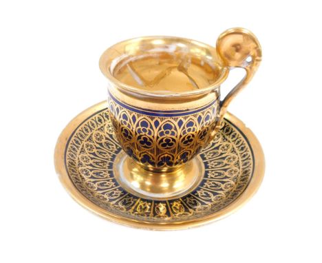 A 19thC French porcelain cabinet cup and saucer, on a gold gilt surround, on a blue ground, 10cm high. (AF)