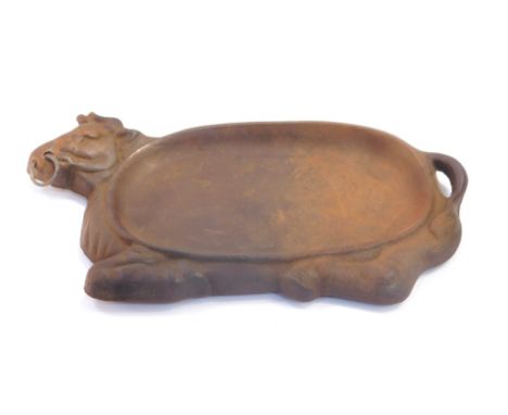 A continental early 20thC cast iron cold meat dish, modeled as a recumbent bull, stamped W K M 2, 30cm wide.