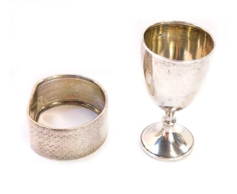 A George V silver egg cup, London c1920, and a silver engine turned napkin ring, Birmingham 1963, 3/4oz. (2)