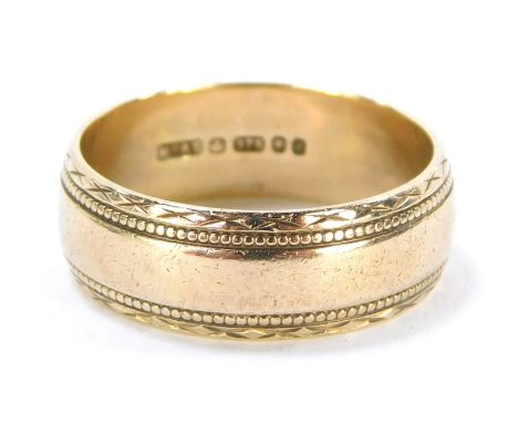 A 9ct gold wedding band, with cross and beaded outer border, ring size K, 3.3g.