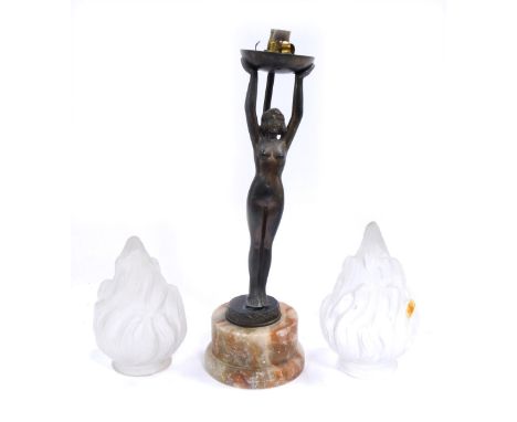 An Art Deco bronzed metal table lamp, with female nude holding shade, with two flared glass shades, on alabaster base, 30cm h