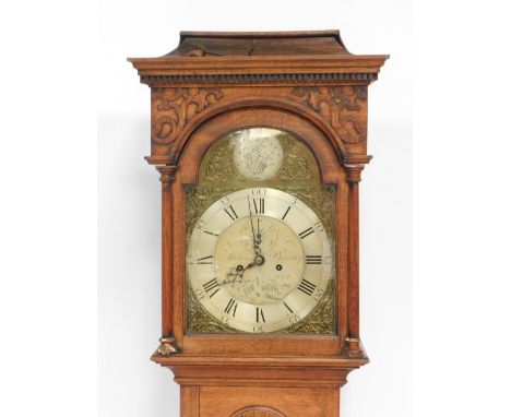 Thomas Beverley. A 19thC oak longcase clock, with a fluted and fret carved top, with two scroll detail, with a brass rococo f