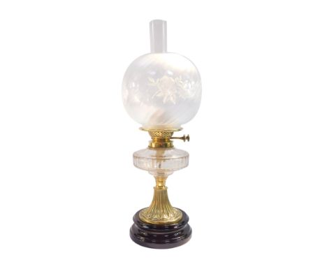 A late 19thC A L Co duplex A1 cut glass and brass oil lamp, raised on a black pottery socle base, with chimney, and frosted f