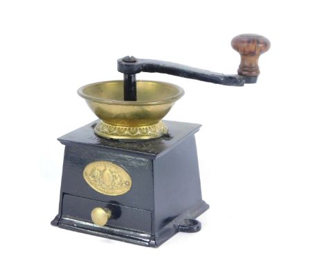 A late 20thC coffee grinder, stamped Baldwin Son &amp; Co with a metal frame and brass plaques, 12cm high. 