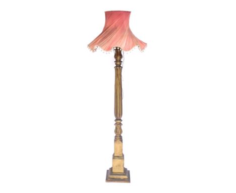 A Victorian style gilt standard lamp, on column supports with pink shade, 191cm high.