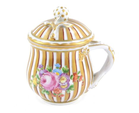 A late 19thC Dresden chocolate pot and cover, the striped gilt decoration and acorn finial top with applied floral spray and 