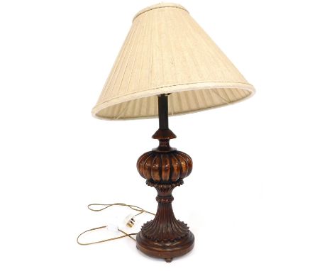 A mahogany table lamp, of bulbous stem design, on a circular foot, with bun feet, with cream shade, 80cm high.