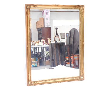 A late 20thC gilt framed rectangular wall mirror, with shell capped corners, and beaded surround, 137cm x 106cm.
