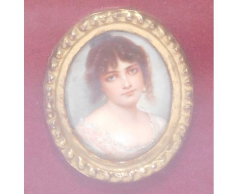An early 20thC portrait miniature, of a lady in cream dress with oval gilt surround, in a velvet cushion lined case, the port