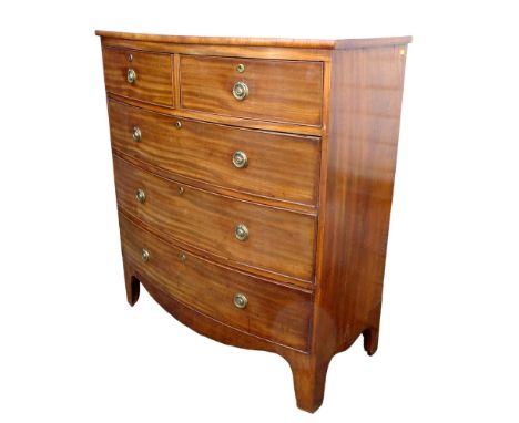 A 19th century bowfront mahogany chest, with two over three drawers, oval brass ring handles, raised upon bracket feet, 102 b