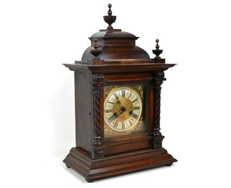 An Edwardian mahogany mantel clock, architectural case with finials, 33 by 19 by 53cm, chime on coil, with pendulum. 
