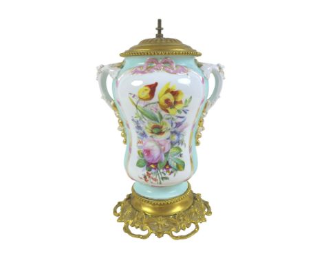 A 20th century ceramic and gilt metal lamp, hand painted with flowers, with moulded twin handles, raised on a moulded gilt me