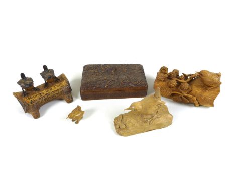 A collection of carved oak ornaments, comprising a Wren Craftsman Sherwood oak carved wren and butterfly sculpture, a floral 