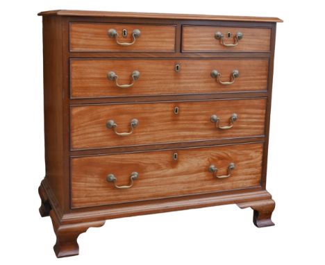 A George III mahogany chest of two over three drawers, with brass swan neck handles, raised upon ogee bracket feet, 88.5 by 4