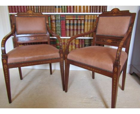 A pair of late 19th century mahogany elbow chairs with trailing floral marquetry detail, raised on square tapered supports, w