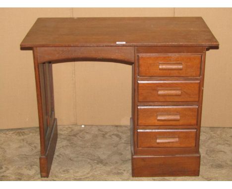 A small vintage child's size oak kneehole single pedestal desk fitted with four drawers within a panelled frame, 84 cm wide x