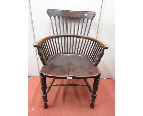 A late 19th century office chair with dished seat in a stick work framework with turned spindle supports and rails 