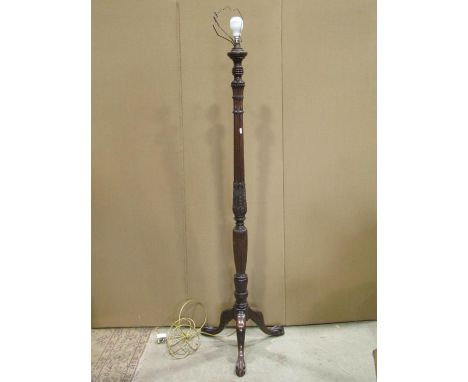 A standard lamp in the hepplewhite style, the turned and reeded column with wheat sheaf detail and swept tripod supports with