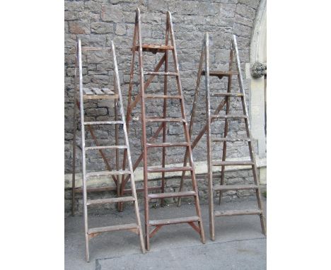 Three vintage wooden folding step ladders of varying height and design, but all with reeded treads (sold for display purposes