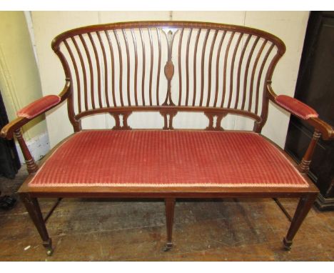 An inlaid Edwardian mahogany parlour room settee, the open framework with shaped wavy stick back, with upholstered seat, set 